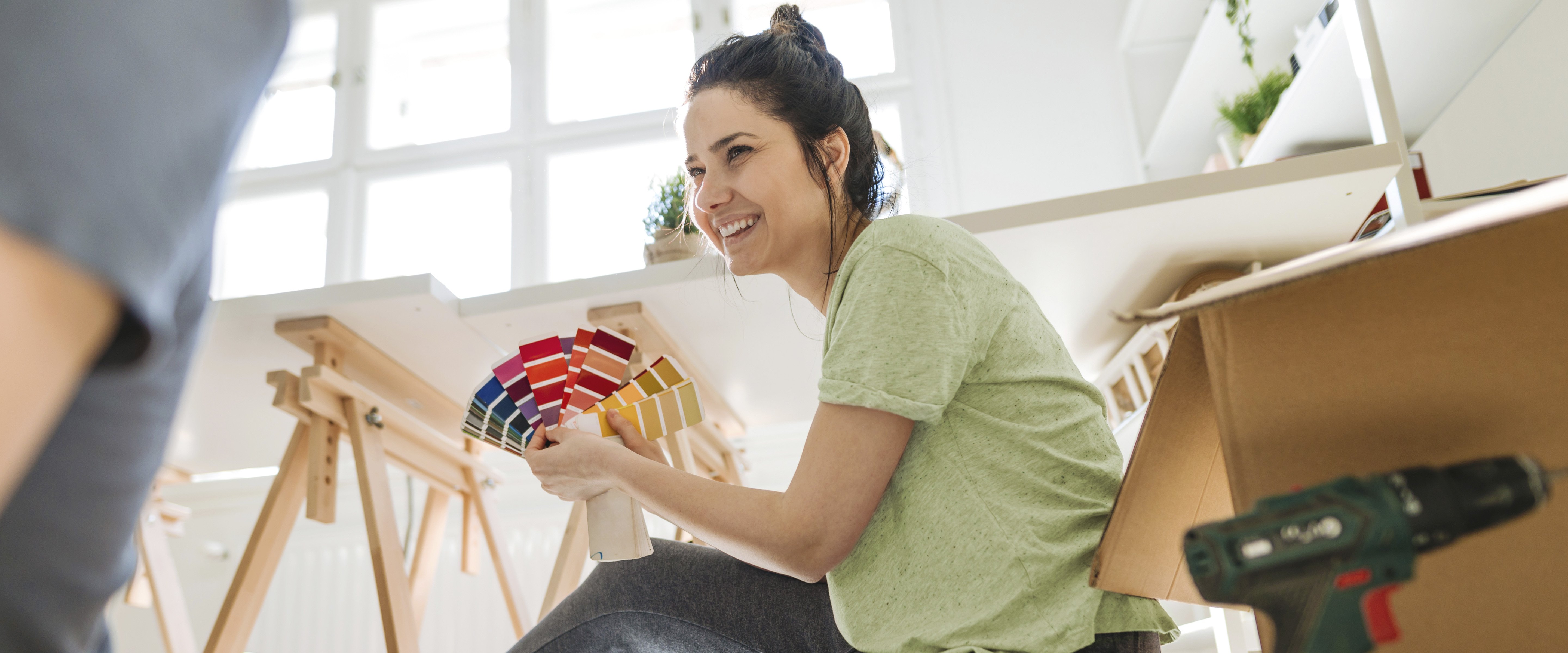 young woman showing paint swatches to husband in new house.jpg