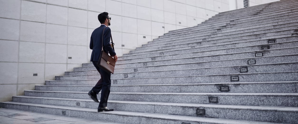 businessman with briefcase walking up stairs.jpg